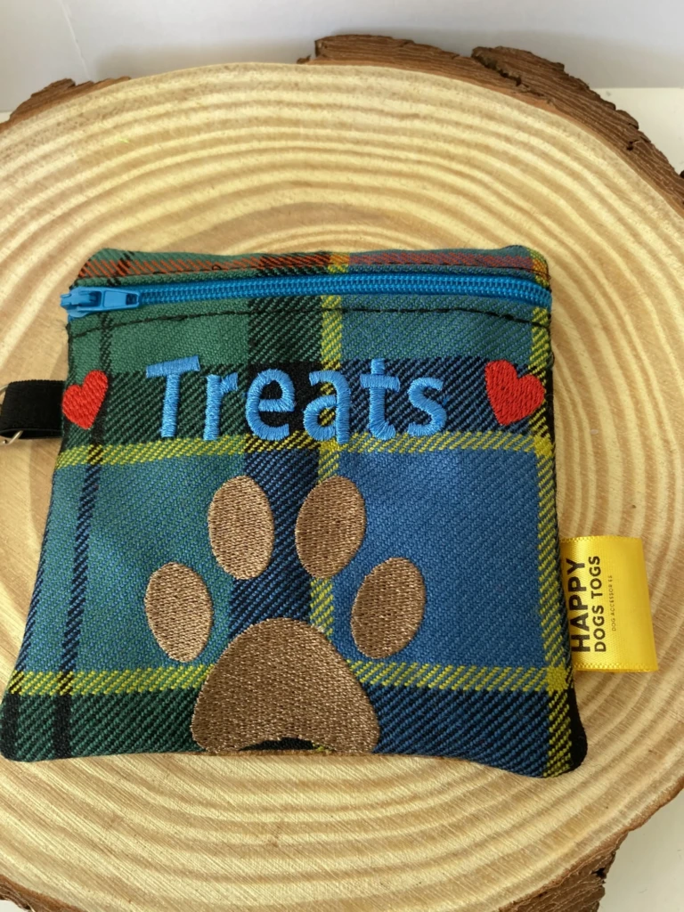 Blue green tartan treats bag on a slice of wood